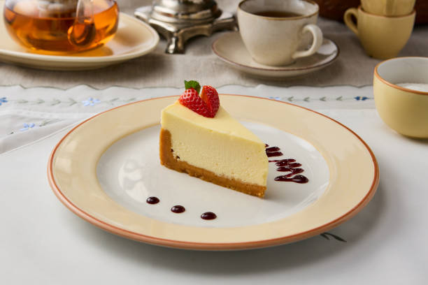 Elegant Presentation of Classic Cheesecake Slice with Warm, Cozy Ambiance.