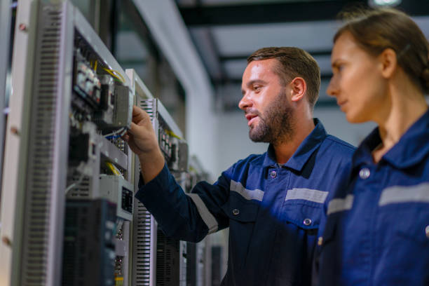 Engineers are working at robotics workshop. Engineers are working at robotics workshop. STEM and technology. energy control room stock pictures, royalty-free photos & images