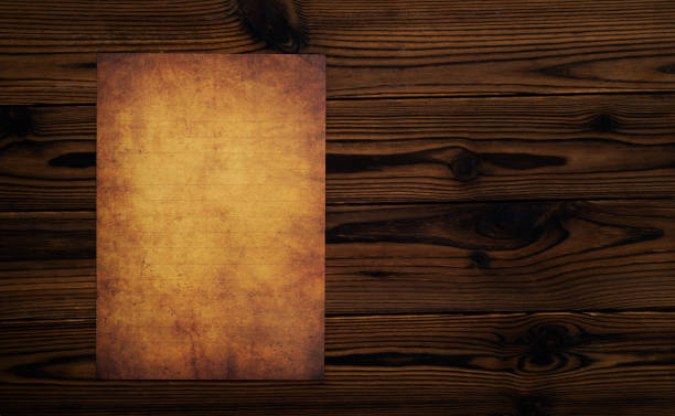 Aged dirty paper on wooden table
