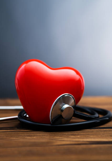 istock Red heart and stethoscope on wooden table 2201215063