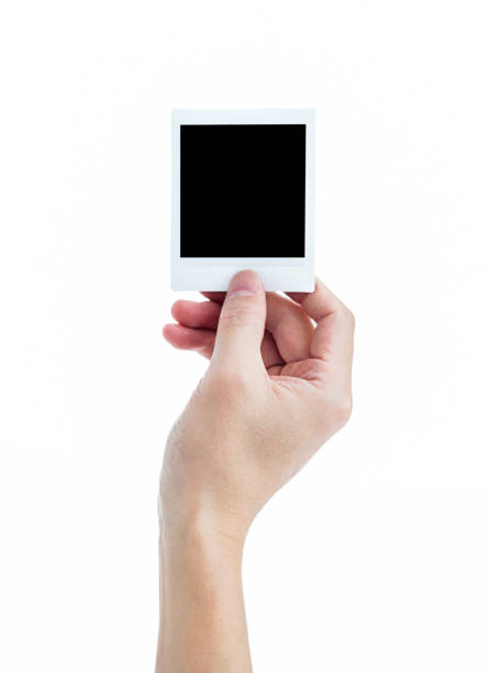istock Human hand holding blank instant photo card on white background 2201215209