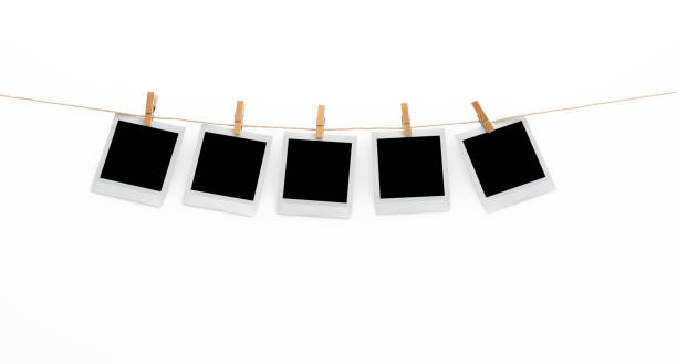 istock Five polaroid pictures hanging on a clothesline with pins on white background 2201215210