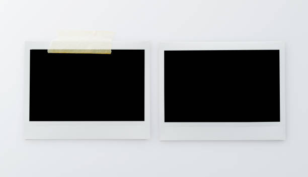 istock Two blank instant picture frame affixed with sticky tape isolated on white background 2201215238