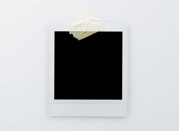 istock Single blank instant picture frame affixed with sticky tape isolated on white background 2201215241