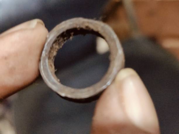 A closeup shot of a man's hand holding a metal nut