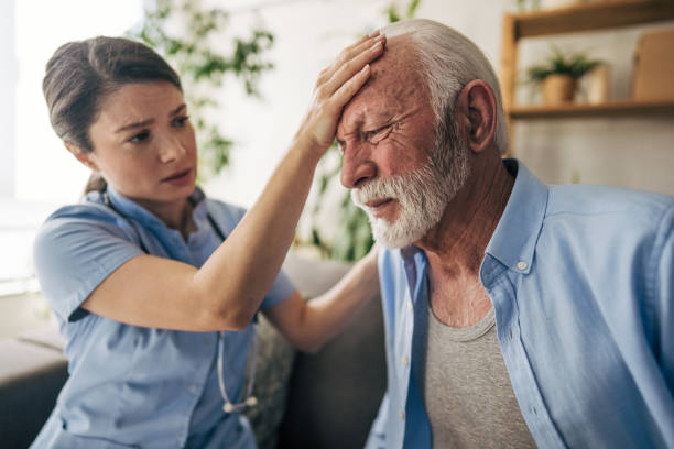 istock Worried nurse checking senior man's forehead temperature at home 2201218269