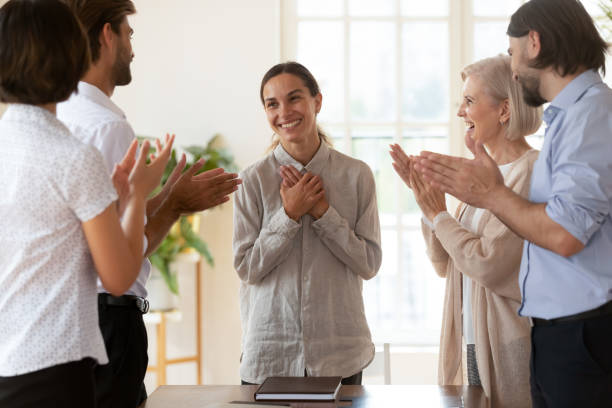 istock Staff encouraging mixed-race newcomer employee at meeting 2201219250