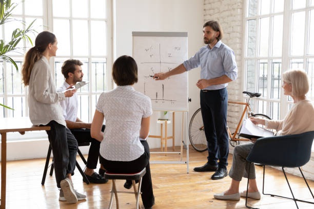 istock Diverse staff take part at corporate training listening business trainer 2201219775