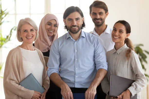 istock 60s and millennial corporate staff photographing smiling looking at camera 2201220924