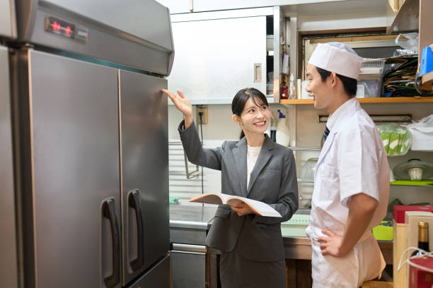 istock A woman who sells refrigerators at a restaurant 2201221995