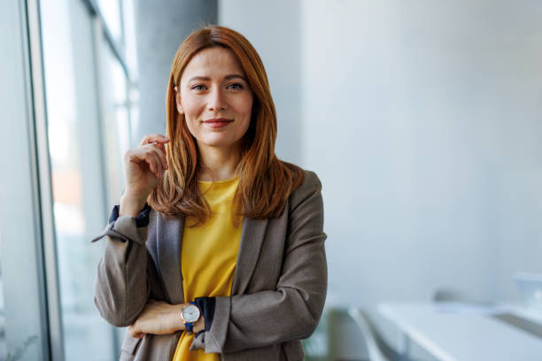 istock Confident businesswoman smiling in modern office space 2201222153