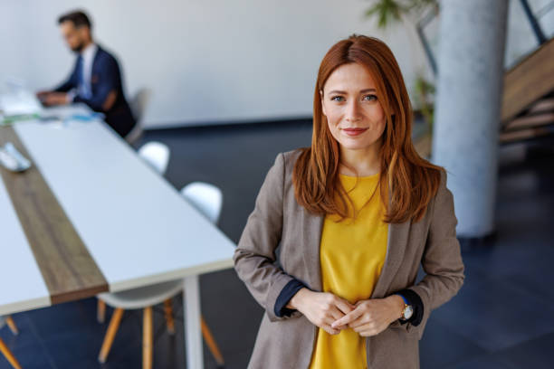istock Confident businesswoman smiling in modern office coworking space 2201222183