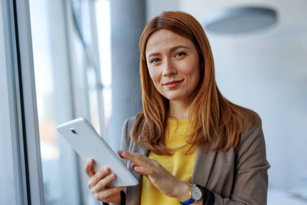 istock Young businesswoman using digital tablet in modern office 2201222197