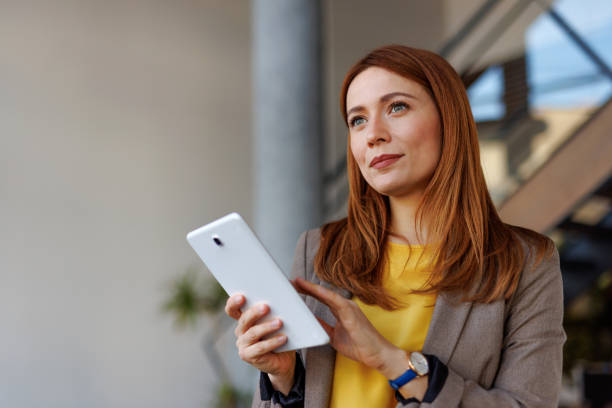Businesswoman using digital tablet in modern office building