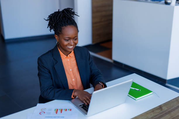 istock Young businesswoman working on laptop in modern office 2201222376