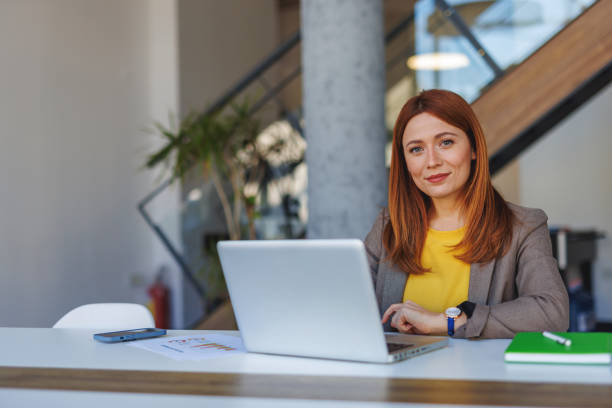 istock Businesswoman working on laptop in modern office 2201222414