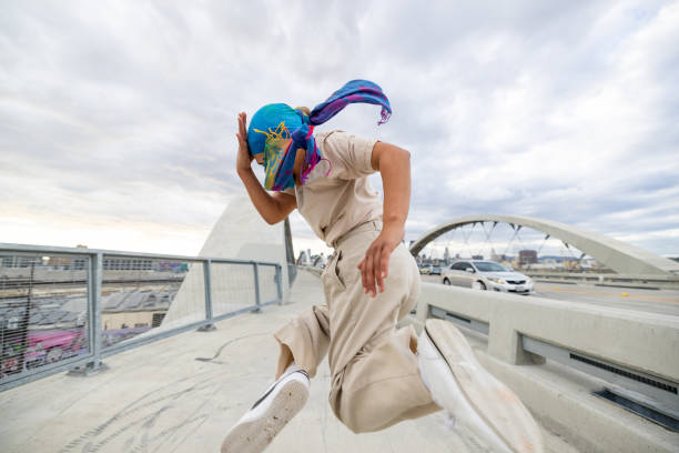 istock Young woman breakdancing in the city streets 2201224378