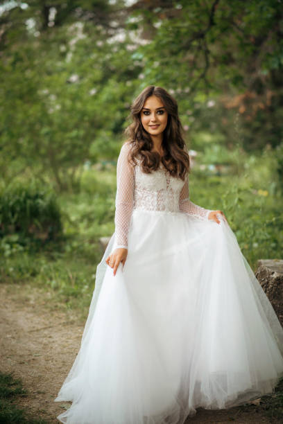 istock young girl bride in a white dress in a spring forest on a wedding day 2201224485