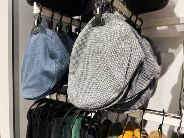 istock Close-up of stylish flat caps displayed on a retail store shelf 2201228275