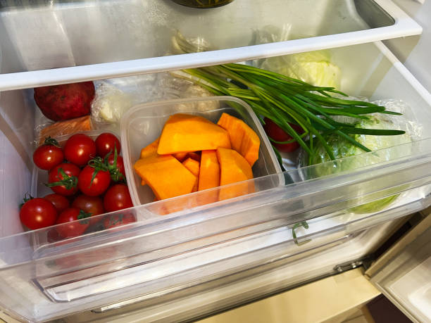 istock Fresh vegetables stored in the refrigerator drawer including tomatoes and pumpkin pieces 2201228300