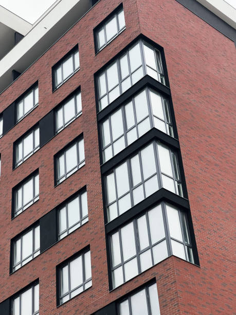 istock Modern brick apartment building with large windows and contemporary architectural design 2201229034