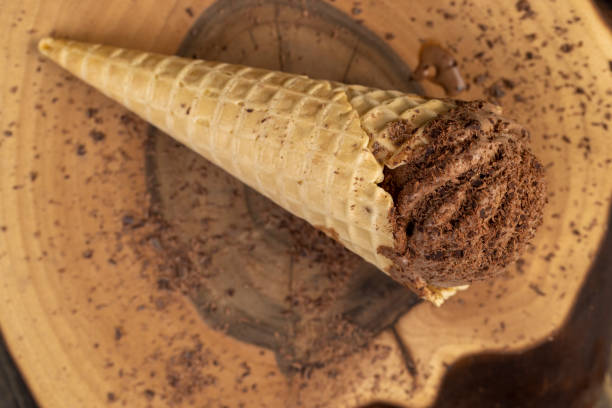 istock chocolate ice cream in a cone on a board 2201229047