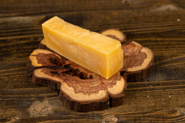 istock a piece of sliced hard mature cheese in close-up 2201229097