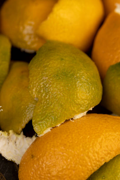 orange and green debris from the peel of tangerines after peeling the fruit