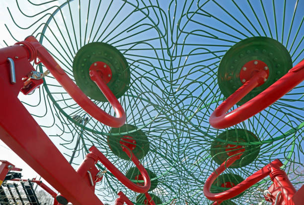istock agricultural machine, also called a rotary tiller or aerator, seen from below with its long, jointed iron pieces used to aerate cut grass. 2201230415