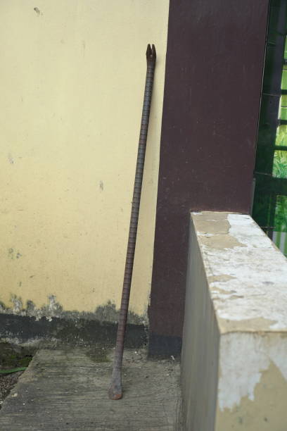 istock Iron crowbar leaning against a textured wall. 2201231228