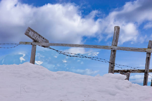 Snowy Alpine Mountain Fence with Sign