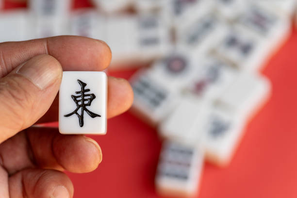A person holding mahjong tiles