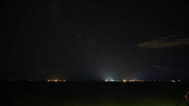 istock Illuminated industrial port city lights under starry night sky 2201235538