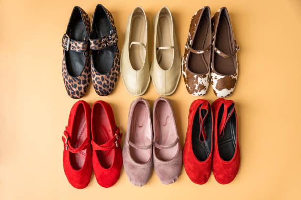 istock Flat lay of stylish ballet flats in various colors and patterns on pastel background 2201237754