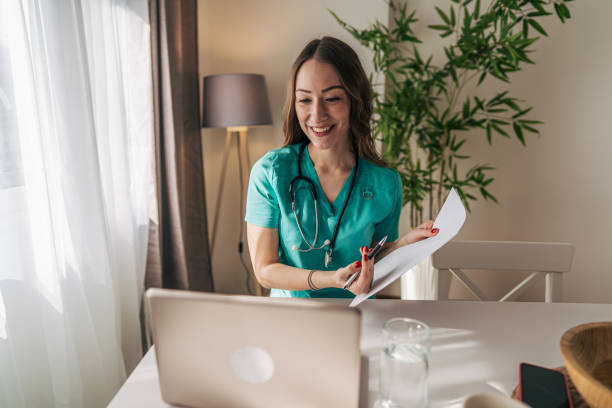 istock Female doctor doing video call with patient from home office 2201239631