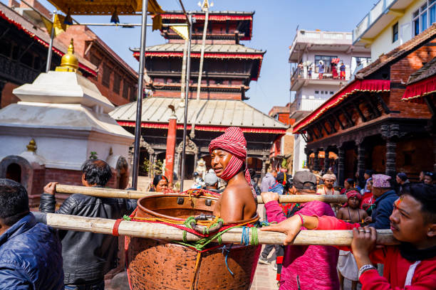 Hindu devotees carrying earthen lamps on their bodies participate in a procession during the Madhab Narayan Deep Yatra festival at Thecho in Lalitpur, Nepal, on Sunday February 09, 2025.