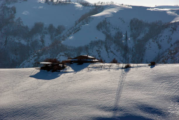 istock Abandoned country house on a snow covered hill 2201241016