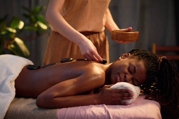 istock Unrecognizable Hands Putting Warm Stones on Female Back 2201246397