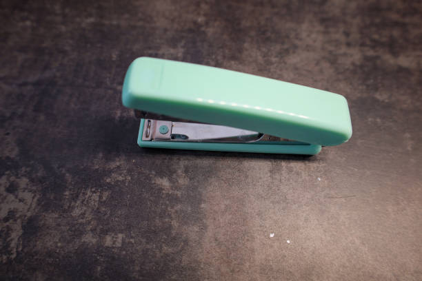 A green stapler isolated on white background