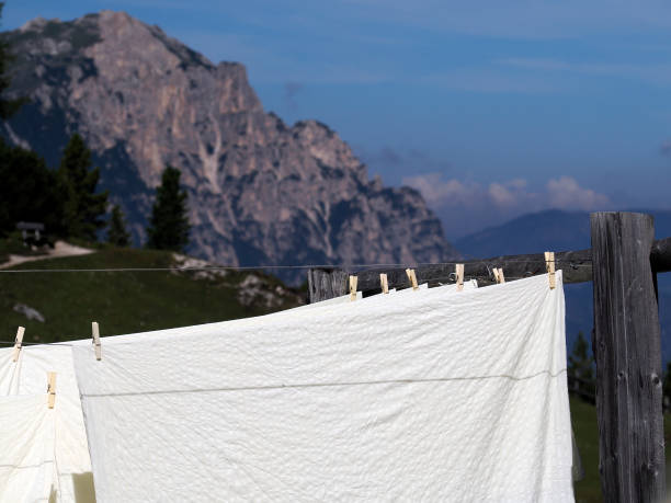 some Bed linen hanging in dolomites mountains summer sun landscape