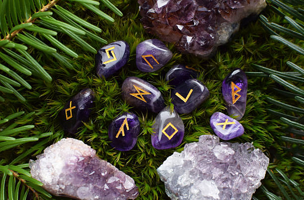 istock Scandinavian amethyst runes on green moss. Predictions, witchcraft, spiritual esoteric practice. 2201252136