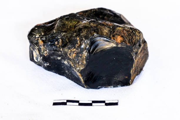 istock A specimen of black Obsidian against a white background with a 5cm scale. 2201252257