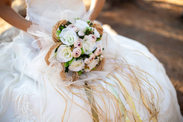 istock Bride sitting and holding flowers 2201258250