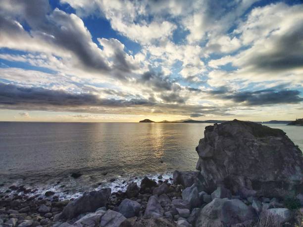 Sunset with sea and Cape Miseno peninsula, photo taken in Pozzuoli bay, Italy