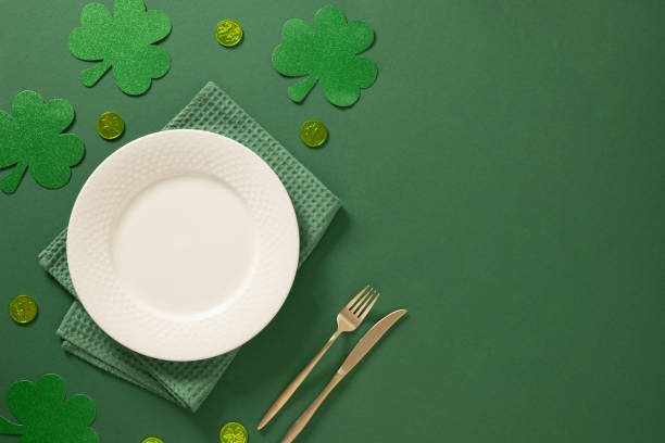 istock St Patrick's Day party table setting with green decoration on green background. 2201271606