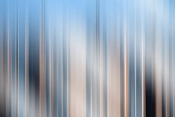 A modern abstract background featuring vertical blue and beige streaks with a motion blur effect. The smooth gradient and soft lines create a dynamic and futuristic look, ideal for contemporary design applications.