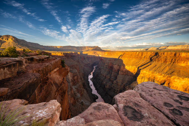 Sunrise at Toroweap Lookout on the North Rim of the Grand Canyon. This stunning overlook showcases dramatic cliffs, deep canyons, the Colorado River and golden light painting the rugged landscape, creating a mesmerizing natural wonder. Toroweap is a very remote location and very challenging to get to.