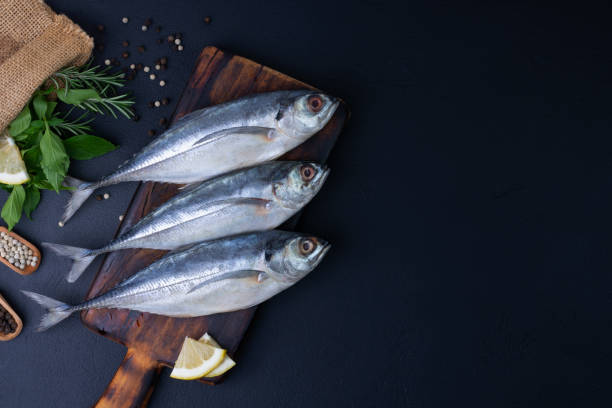 istock Raw mackerel, seafood, ready to cook on black background 2201277587