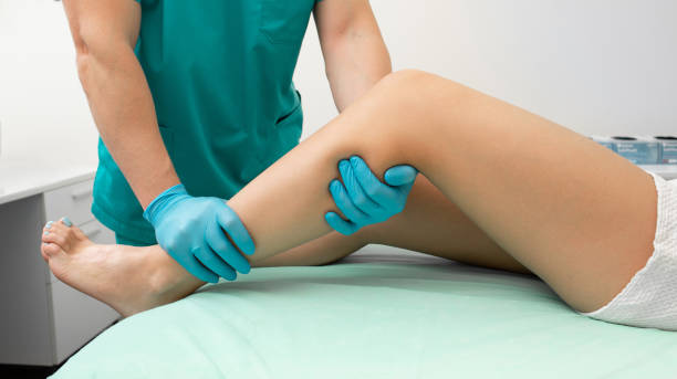 istock Osteopath doing a diagnosis of a woman's leg. Woman may have a broken leg 2201279746