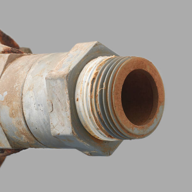 close-up of threaded end of old pvc pipe fittings with dirt and muddy inside area isolated gray background, plumbing system or industrial machinery concept